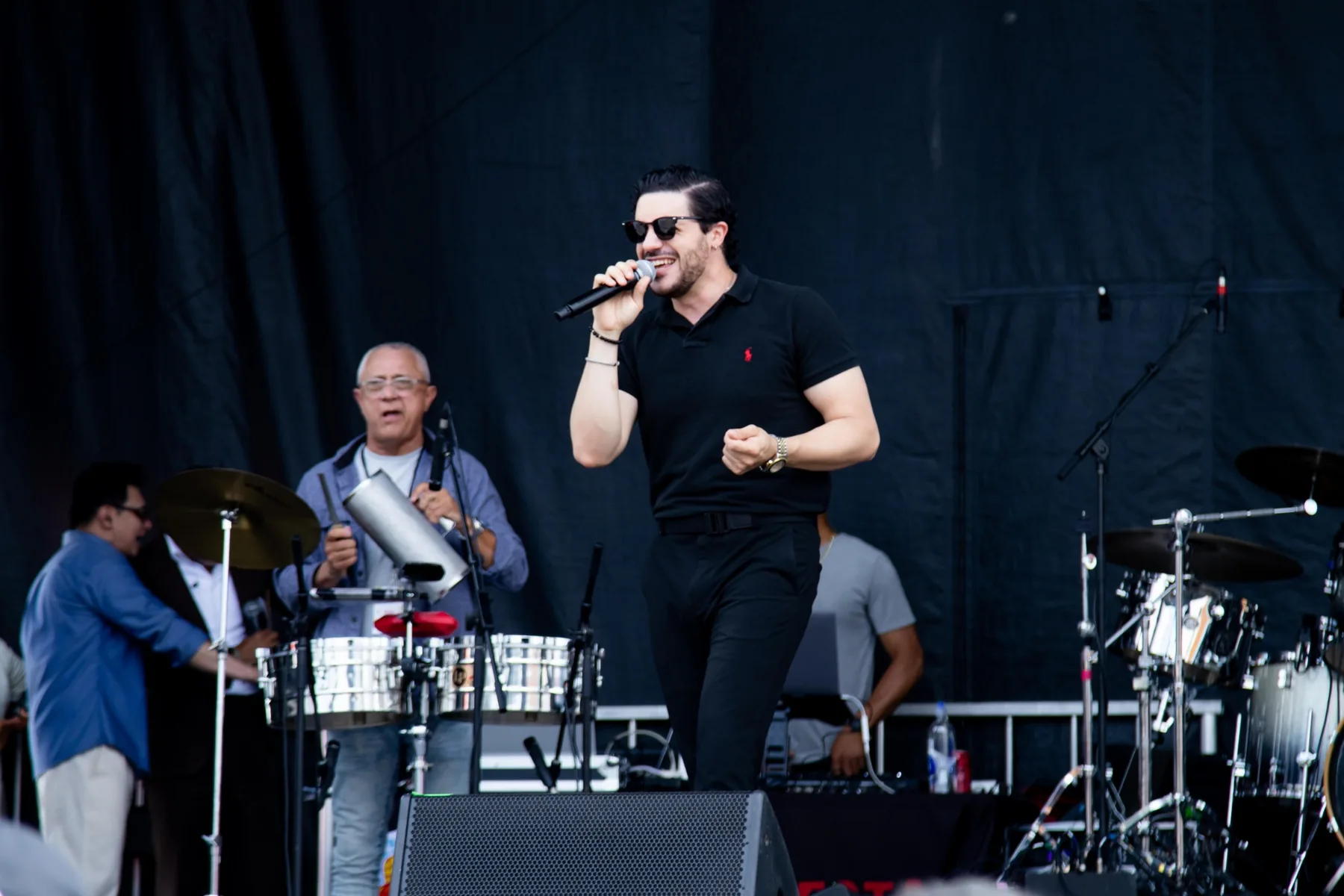 HighLatin performing on an outdoor stage